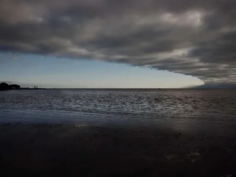 A cold front leaving the city as evidenced by this thick band of clouds. 