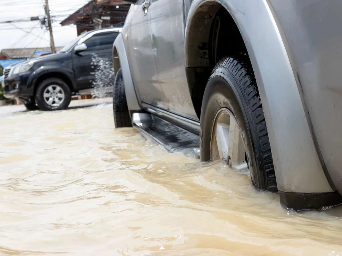 These people are showing an error in judgment by driving on flooded roads.