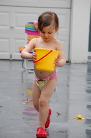 little-girl-playing-in-the-rain-by-teddyb.jpg