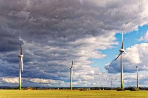 Mostly cloudy skies and windmills.