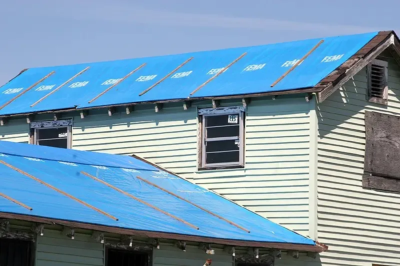 This is the blue tarp roof covering  provided by FEMA after a hurricane -- it protects the ENTIRE roof, rather than simply patching a small roof leak.